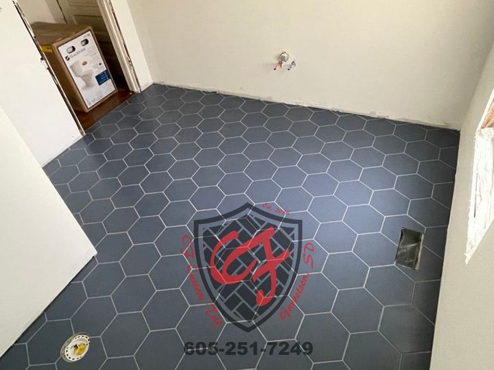 Dark gray hexagon tile floor in an empty room